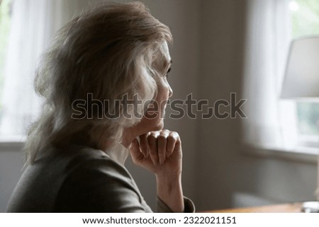 Close up side view of sad pensive old Caucasian woman look in window distance thinking pondering. Unhappy middle-aged female feel depressed distressed, suffer from solitude loneliness at home. Royalty-Free Stock Photo #2322021151