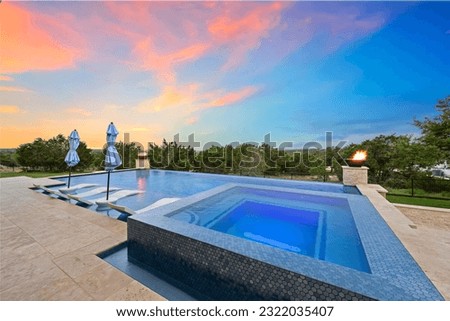 a luxury pool at sunset  Royalty-Free Stock Photo #2322035407