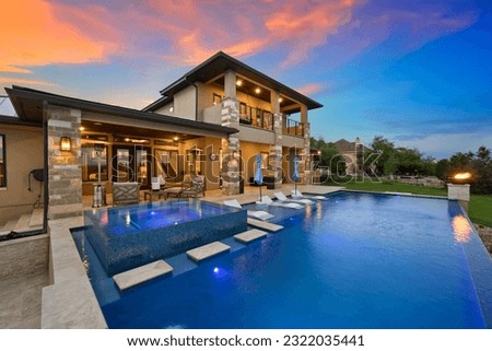 a luxury pool at sunset  Royalty-Free Stock Photo #2322035441