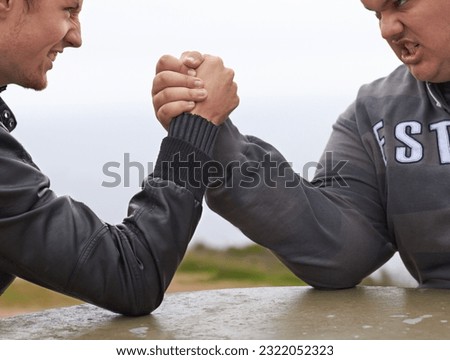Closeup, friends and competition with men and arm wrestling in nature for challenge, power and respect. Team, strong and conflict with hands of people and holding hands for muscle, match and rival