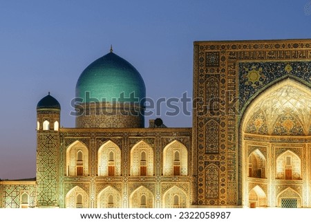 Evening view of awesome blue dome of the Tilya-Kori Madrasah at the Registan Square in Samarkand, Uzbekistan. The Registan is a popular tourist attraction of Central Asia. Royalty-Free Stock Photo #2322058987