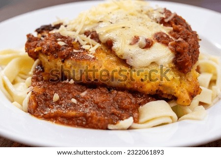 Homemade Chicken Parmesan served with Fettuccine and Marinara Sauce Royalty-Free Stock Photo #2322061893