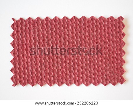 Red fabric swatch cut with pinking shears zig zag scissors