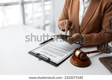 Businesswoman, lawyer using mobile phone to contact Chat online, use a laptop to check details and look at the information before signing the terms and conditions. business concept justice
