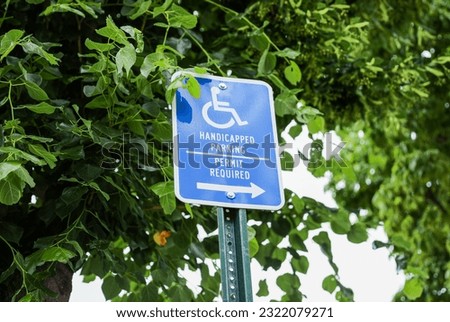 Close-up of a blue and white handicap sign, symbolizing accessibility, inclusivity, and accommodations for individuals with disabilities