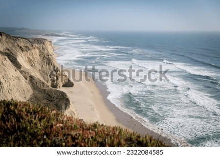 Rocky coast of Northern California , blue ocean waves, cliffs and sandy beach