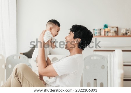 Asian adorable baby in a good mood, Enjoy playing with father. Father holding little baby and playing. Fathers day concept. Royalty-Free Stock Photo #2322106891