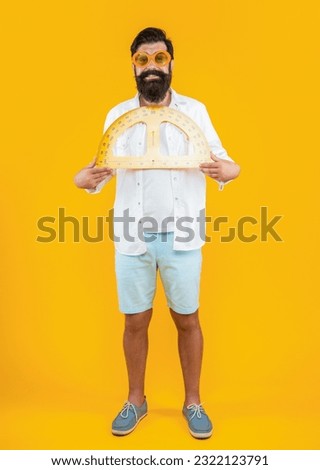 cheerful man with geometry protractor on background. photo of man with geometry protractor.