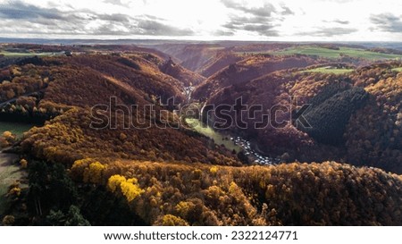 fall autumn aerial view rock with medieval castle Ehrenburg on it near moselle river in Brodenbach with forest hills