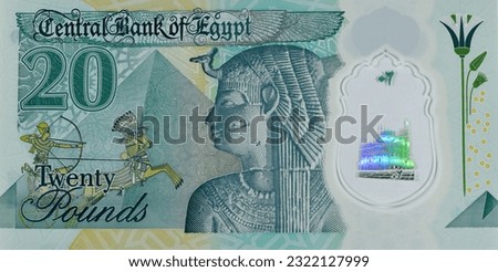 Large fragment of the reverse side of the new Egyptian 20 EGP LE twenty polymer pounds cash money banknote bill features queen Cleopatra, the Great Pyramids along with the pharaonic military chariot Royalty-Free Stock Photo #2322127999