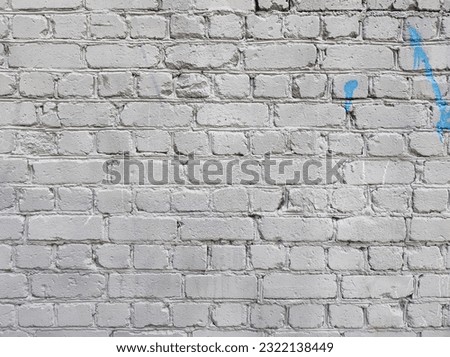 Grey old brick wall background texture with blue paint on it free space for text and graphics
