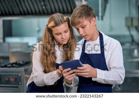 Two student use tablet for studying in cooking class in real kitchen , Kitchen education concept.