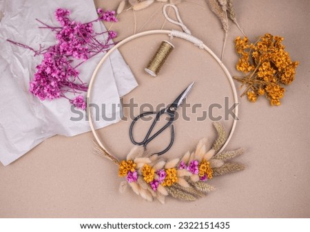 Tying a wreath from dried flowers, flower wreath tying, handmade, do it yourself Royalty-Free Stock Photo #2322151435