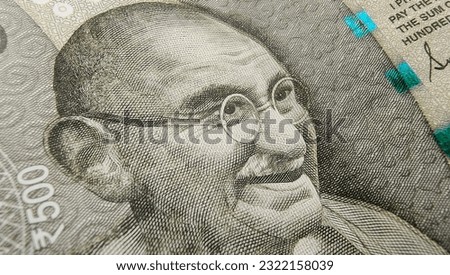 Indian rupee currency note or reserve bank of India paper money extreme macro detail close up of Mahatma Gandhi portrait. Inflation, banking, savings, investment, tax, wealth and cash concept. Royalty-Free Stock Photo #2322158039