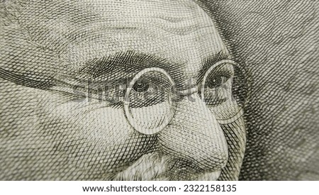Indian rupee currency note or reserve bank of India paper money extreme macro detail close up of Mahatma Gandhi eyes. Inflation, banking, savings, investment, tax, wealth and cash concept. Royalty-Free Stock Photo #2322158135