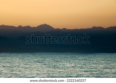 A picture of a mountain overlooking the sea