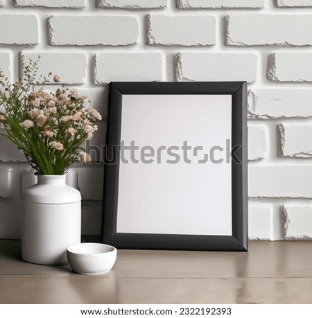 Black frame mockup with flowers bouquet in white vase near white painted brick wall. Empty frame mock up for presentation artwork. Template framing for modern art.