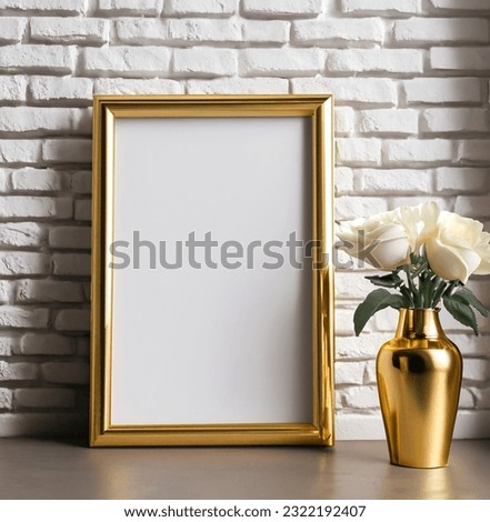 Golden frame mockup with flowers bouquet in gold vase near white painted brick wall. Empty frame mock up for presentation artwork. Template framing for modern art.
