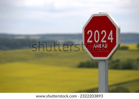 2024 ahead new year road sign on mountain landscape