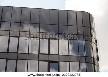 Tinted glass facade. Rounded corner glasses, elements of modern architecture.