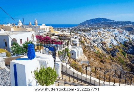 Panoramic view of picturesque Santorini or Thira island Cyclades,Fira-capital town and ornamental blue vase on the foreground,Greece.Picture taken on September 7th 2013
