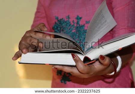 Close up on woman's hands turning pages in a vintage book. A woman read a book. Selective focus, book close-up.