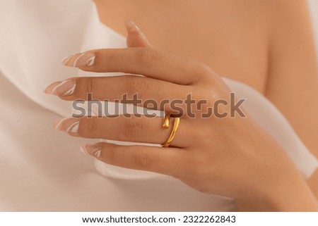Gorgeous rings on the buyer and brunette girl with well-groomed nails. Ring photo for e-commerce and online selling.