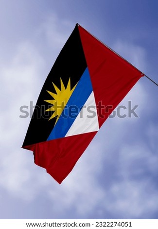 3d illustration flag of Antigua and Barbuda. Antigua and Barbuda flag isolated on the blue sky with clipping path.