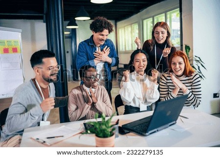 Multiethnic coworkers have an online meeting with their boss.They are hearing some exciting news and are very happy Royalty-Free Stock Photo #2322279135
