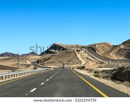 Road in Israel along the border with Egypt and an Egyptian observation post Royalty-Free Stock Photo #2322294759