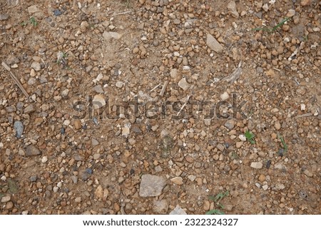 abstract background texture of stone pebbles on brown ground