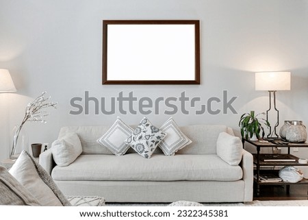 Minimal Modern Living Room Interior with Elegant Styled Home Decor and Linen Couch and Blank Dark Wood Photo Frame Mockup Royalty-Free Stock Photo #2322345381