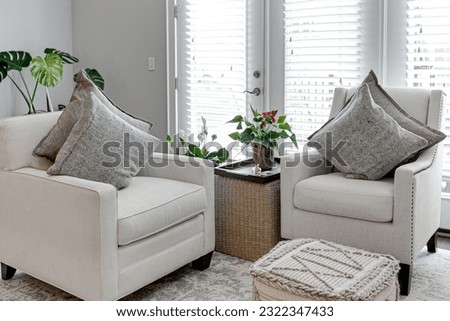 Modern Home Living Interior with Two Sustainable Fabric Accent Chairs with Throw Pillows and House Plants Royalty-Free Stock Photo #2322347433