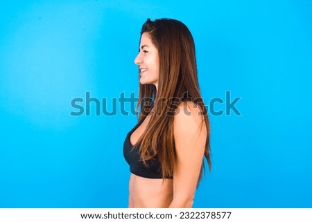 Profile of smiling Young beautiful brunette woman wearing sportswear with healthy skin, has contemplative expression, ready to have outdoor walk.