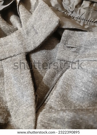 Clothing element, zipper, fastener. Grey wool template. Background design, photography. Textile, fabric template