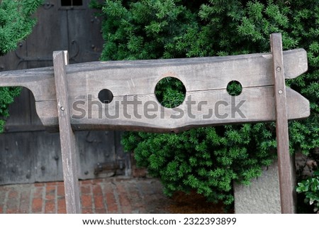 Medieval wooden stocks in the courtyyard of the castle