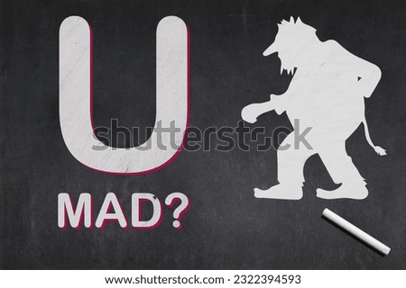 Blackboard with drawn on it a short phrase saying : “U MAD?” next to a troll.