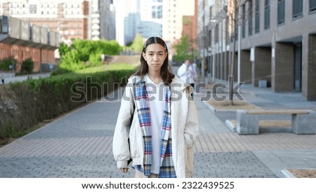Young cute teenage girl walking down the street enjoying a summer walk