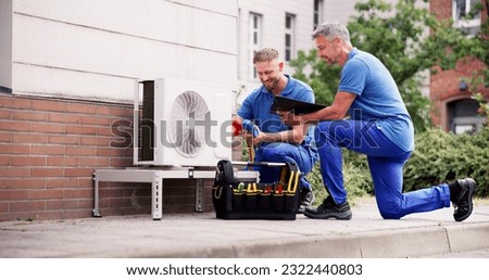 Industrial Air Conditioning Technician. HVAC Cooling System Repair Royalty-Free Stock Photo #2322440803