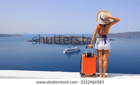 Happy moment with young woman tourist as orange the luggage in Santorini island,Greece 