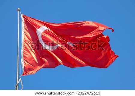 Waving Turkish flag. Sky background.Flag with star and crescent symbol