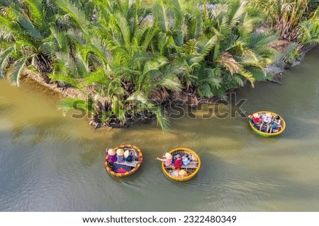 Aerial view, tourists from Thailand, Korea, America and Japan are relax and experiencing a basket boat tour at the coconut water ( mangrove palm ) forest in Cam Thanh village, Hoi An,Quang Nam,Vietnam
