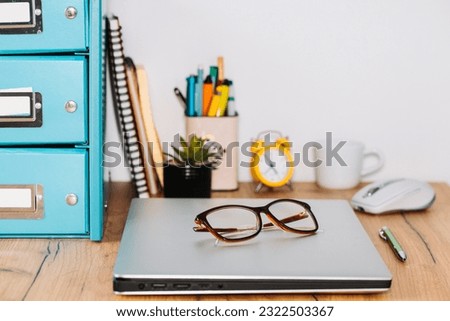 the closed notebook computer was placed on the desk in the office, concept, end of work, vertical photo