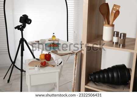 Professional equipment and composition with spaghetti on white wooden table in studio. Food photography