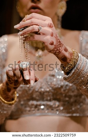 bride wearing bangles hand closeup bride getting ready for wedding ceremony Royalty-Free Stock Photo #2322509759