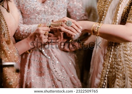 bride wearing bangles hand closeup bride getting ready for wedding ceremony Royalty-Free Stock Photo #2322509765