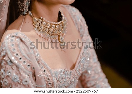 bride wearing bangles hand closeup bride getting ready for wedding ceremony Royalty-Free Stock Photo #2322509767