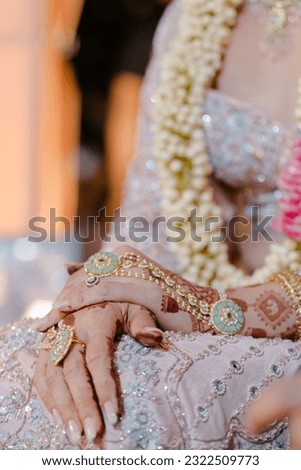 bride wearing bangles hand closeup bride getting ready for wedding ceremony Royalty-Free Stock Photo #2322509773