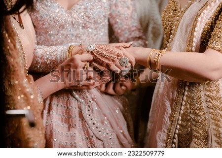 bride wearing bangles hand closeup bride getting ready for wedding ceremony Royalty-Free Stock Photo #2322509779