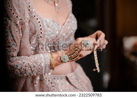 bride wearing bangles hand closeup bride getting ready for wedding ceremony Royalty-Free Stock Photo #2322509783